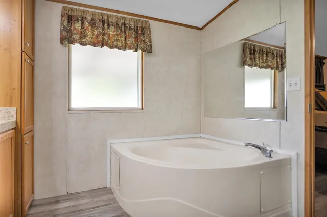 a white bath tub sitting next to a window