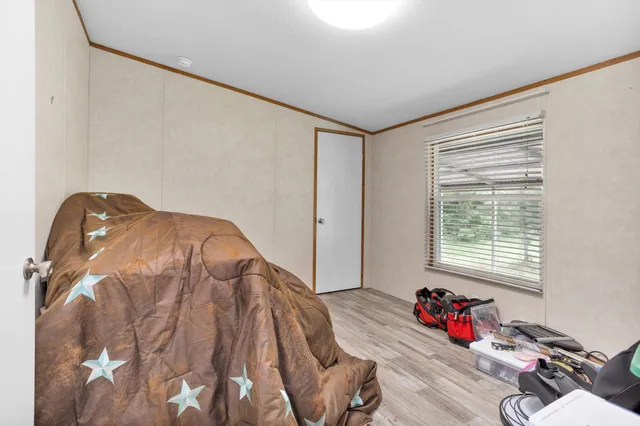 a bed sitting in a bedroom next to a window