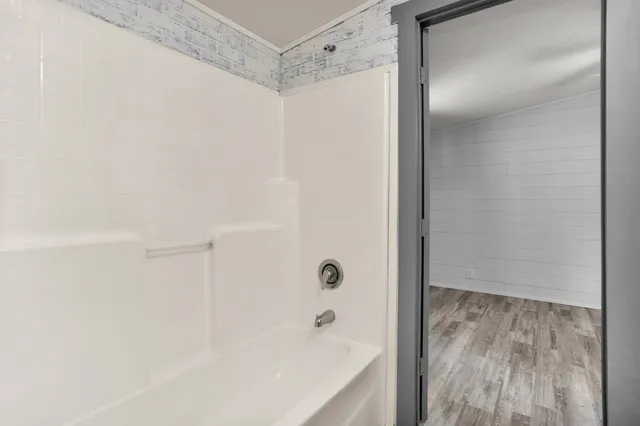 a bathroom with a bathtub and a shower