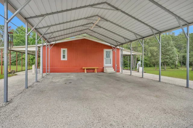 a view of a house with a small yard and sitting area