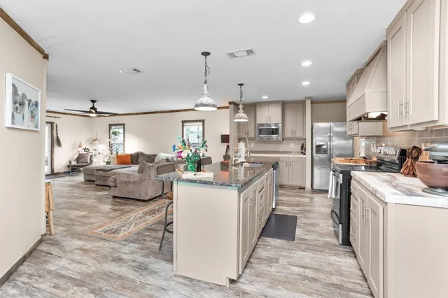 a kitchen with counter top space a sink cabinets and appliances