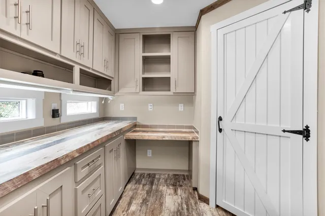 a kitchen with stainless steel appliances granite countertop a sink and a white cabinets