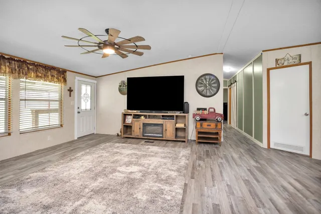 a view of a livingroom with furniture and a flat screen tv