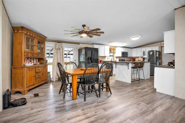 a view of a dining room with furniture and wooden floor