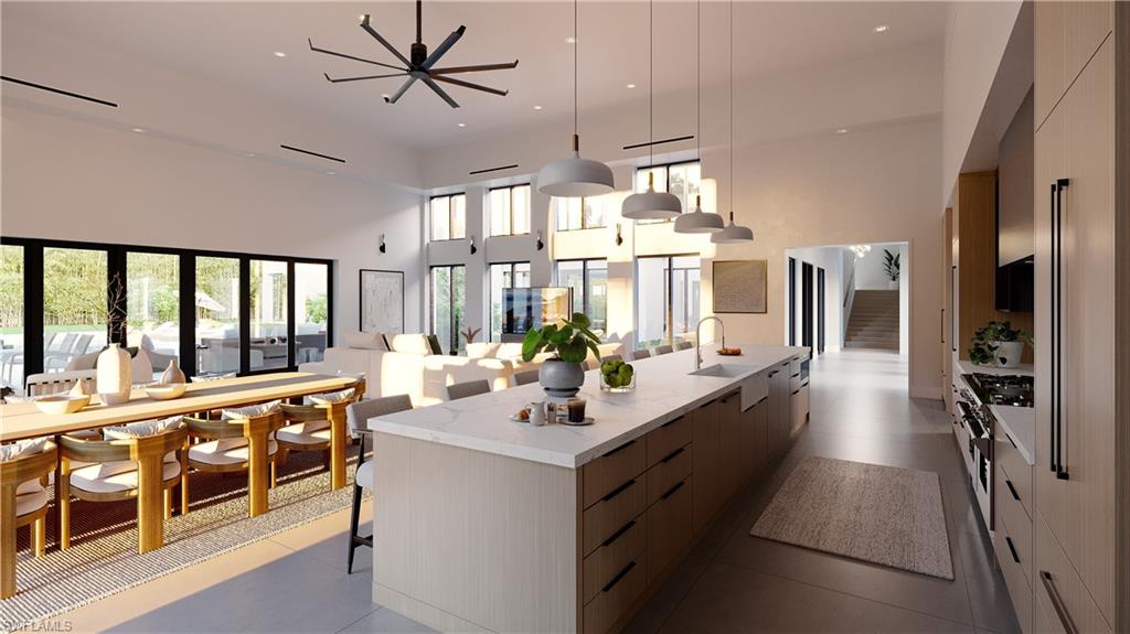 4696 3rd Avenue Northwest Naples, FL 34119 - Photo 4 of 12 a large white kitchen with a large window and stainless steel appliances