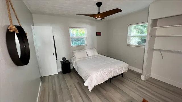 a bedroom with a bed a dresser and a window