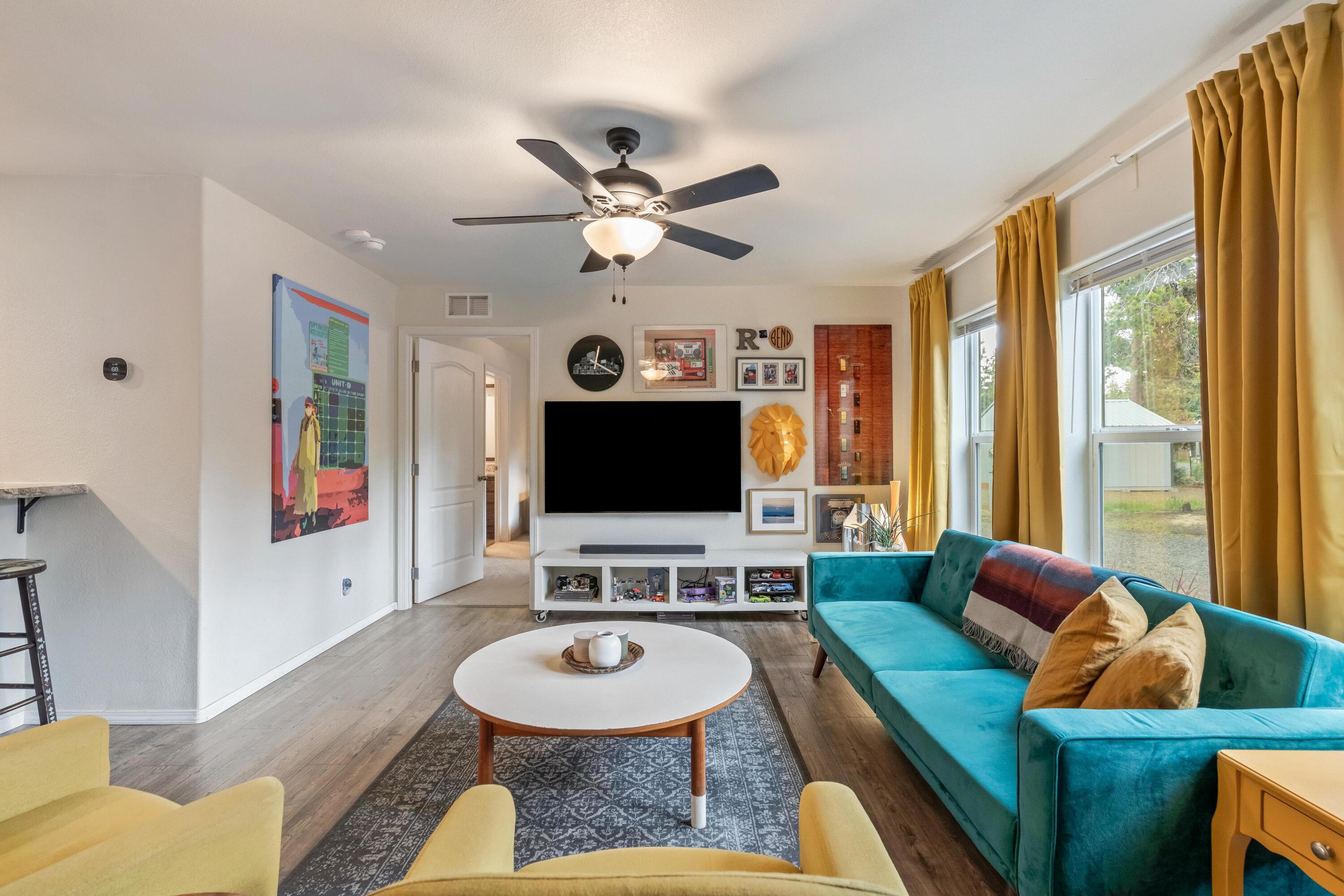 55823 Snow Goose Road Bend, OR 97707 - Photo 5 of 36 a living room with furniture and a flat screen tv