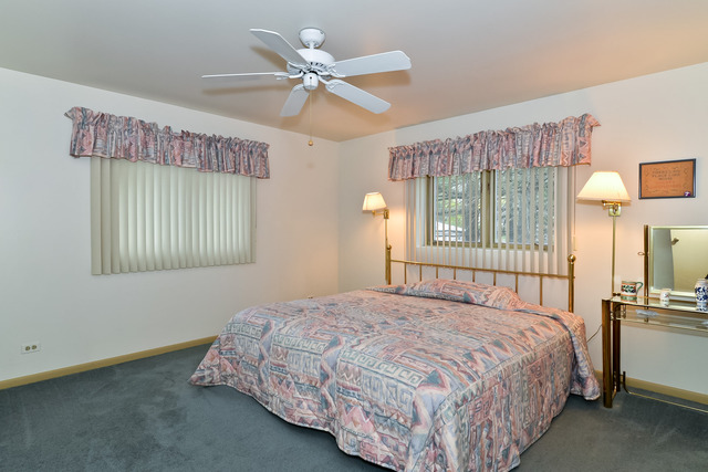 1326 Linden Road Homewood, IL 60430 - Photo 6 of 10 a bedroom with a bed mirror and a window
