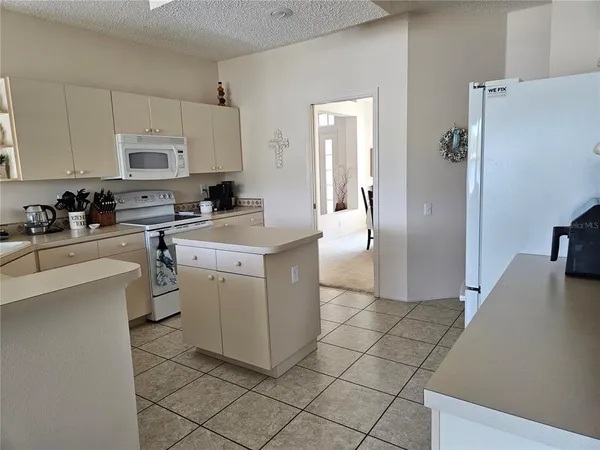 a kitchen with a sink a stove and refrigerator