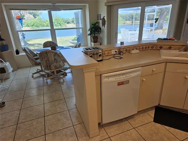 a view of a kitchen with furniture and windows