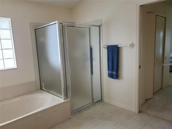 a bathroom with a shower and a glass door