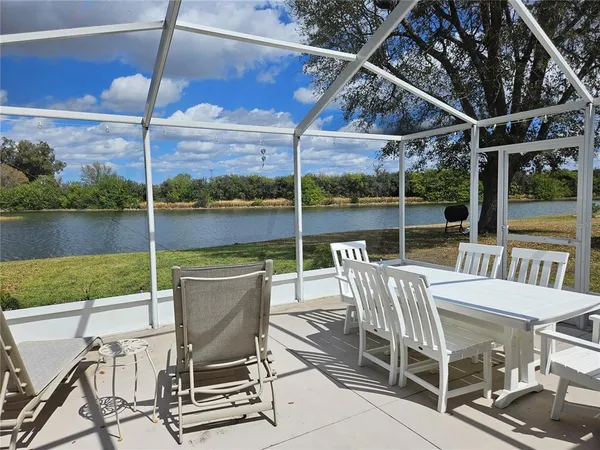 a view of a patio with a table chairs and backyard