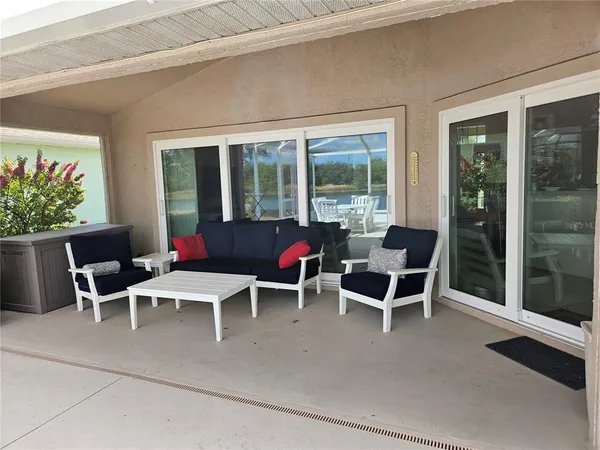 a building outdoor space with patio furniture and potted plants