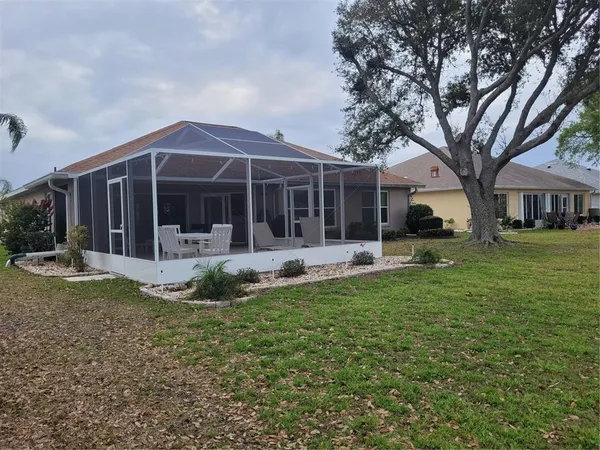a view of a house with a yard and sitting area