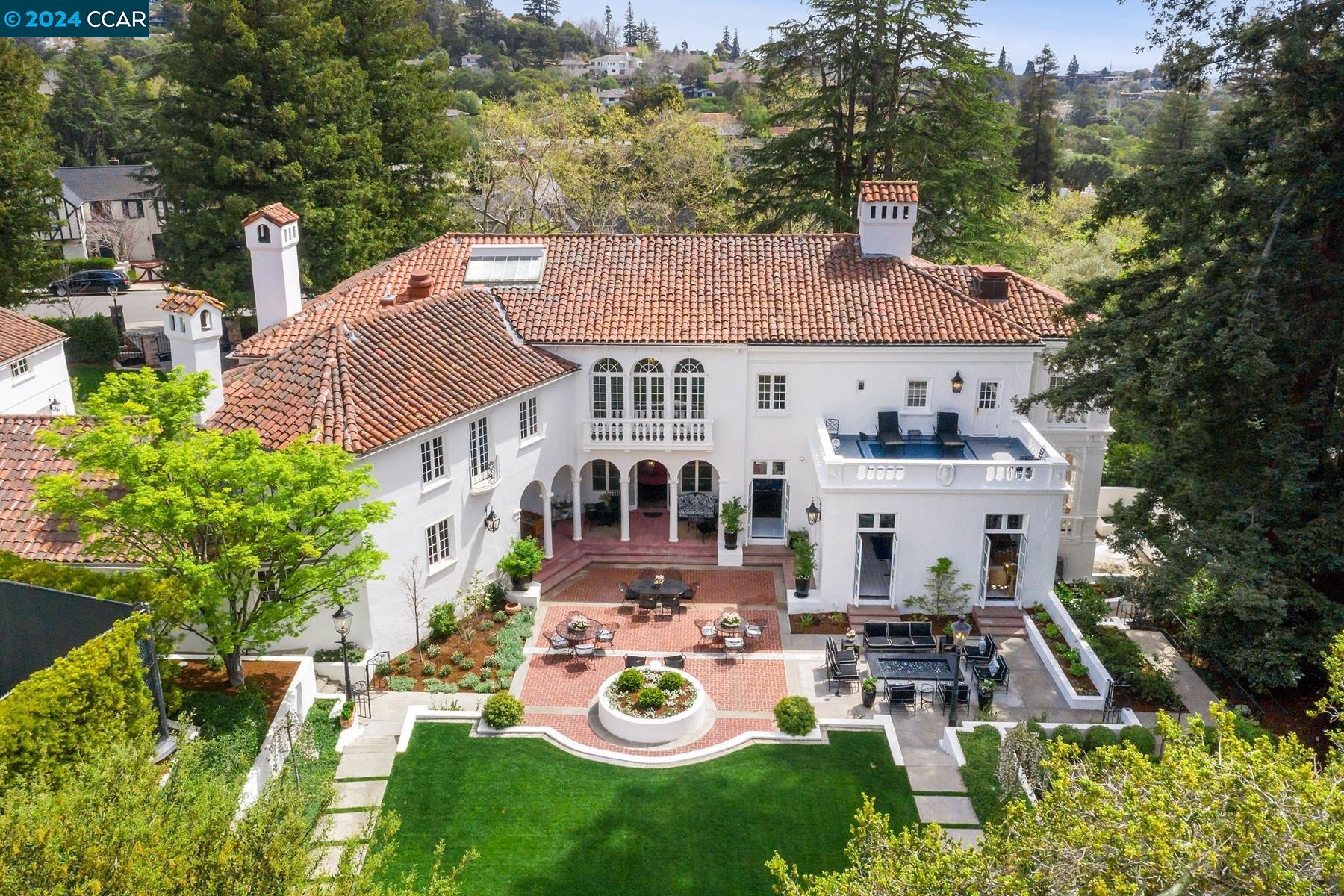 a view of a house with table and chairs in patio