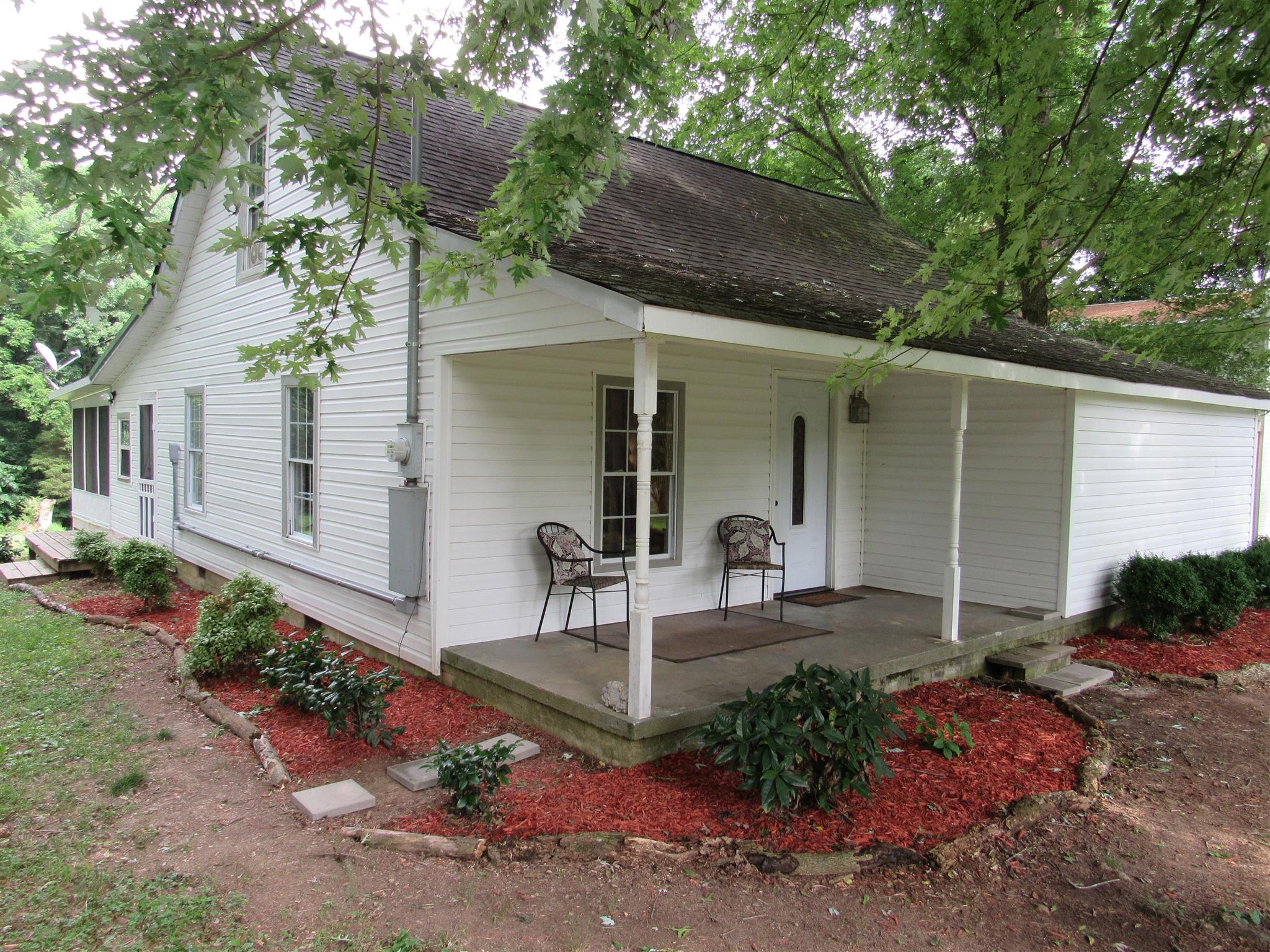 a view of a chair and table in backyard