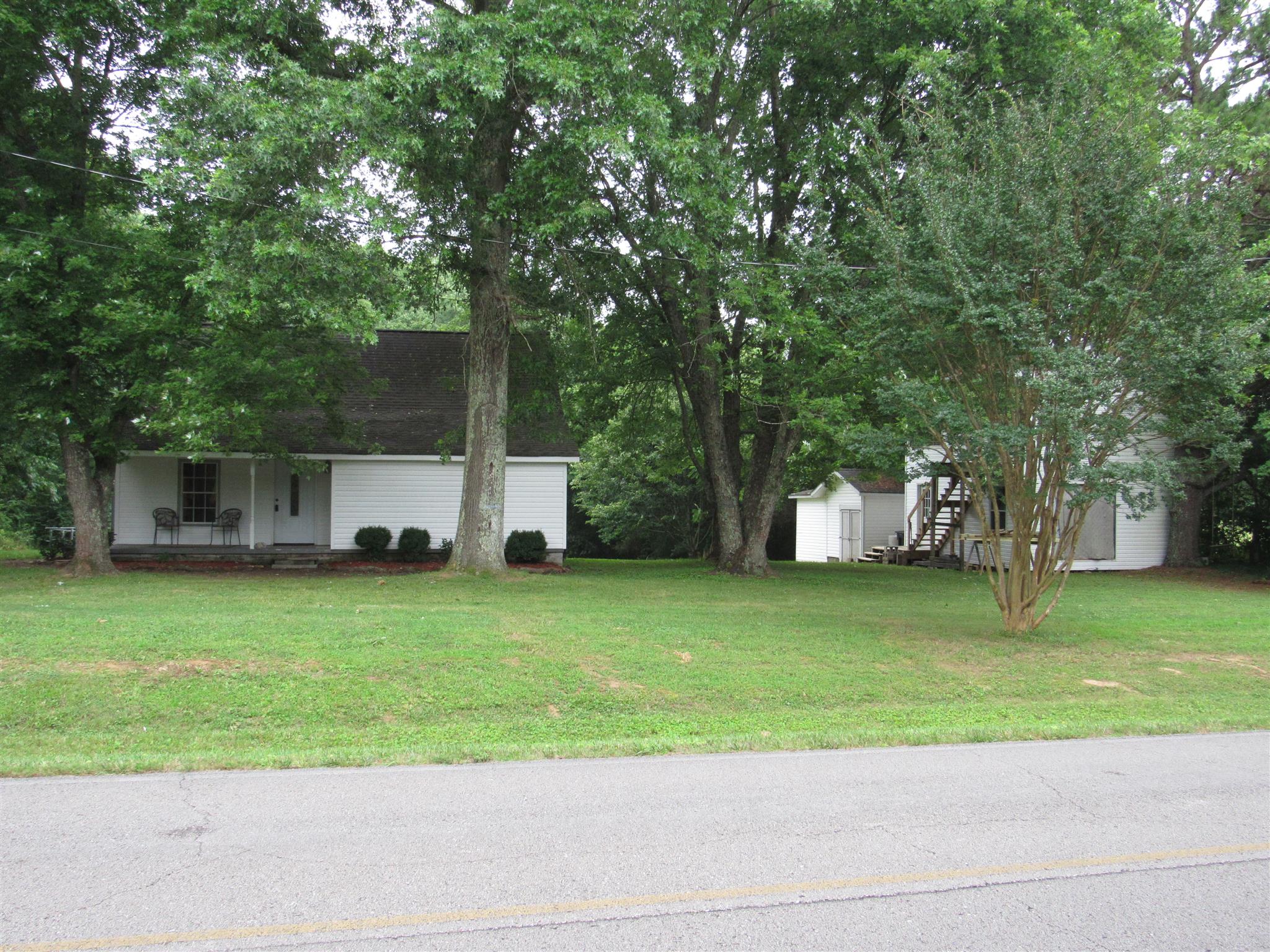 5354 Cathey Ridge Road Manchester, TN 37355 - Photo 21 of 22 a front view of a house with a garden and trees