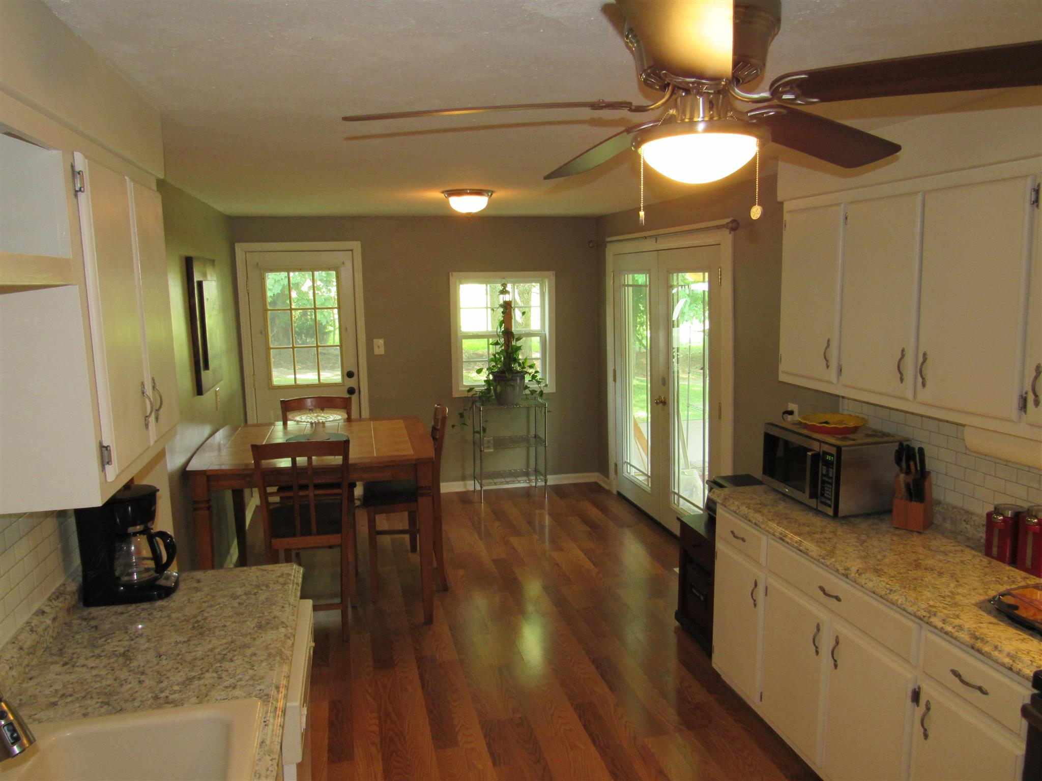 5354 Cathey Ridge Road Manchester, TN 37355 - Photo 7 of 22 a kitchen with sink cabinets and wooden floor