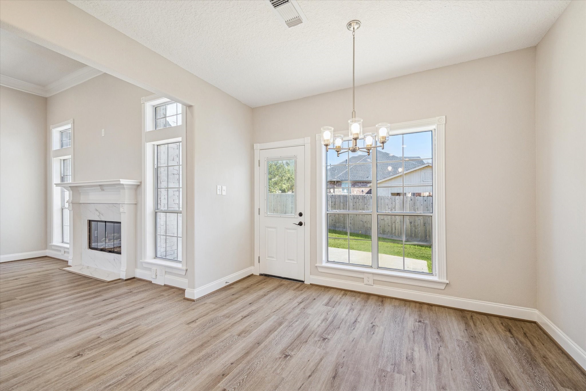 5437 Edgewater Court Willis, TX 77318 - Photo 18 of 29 a view of a room with wooden floor fireplace and windows