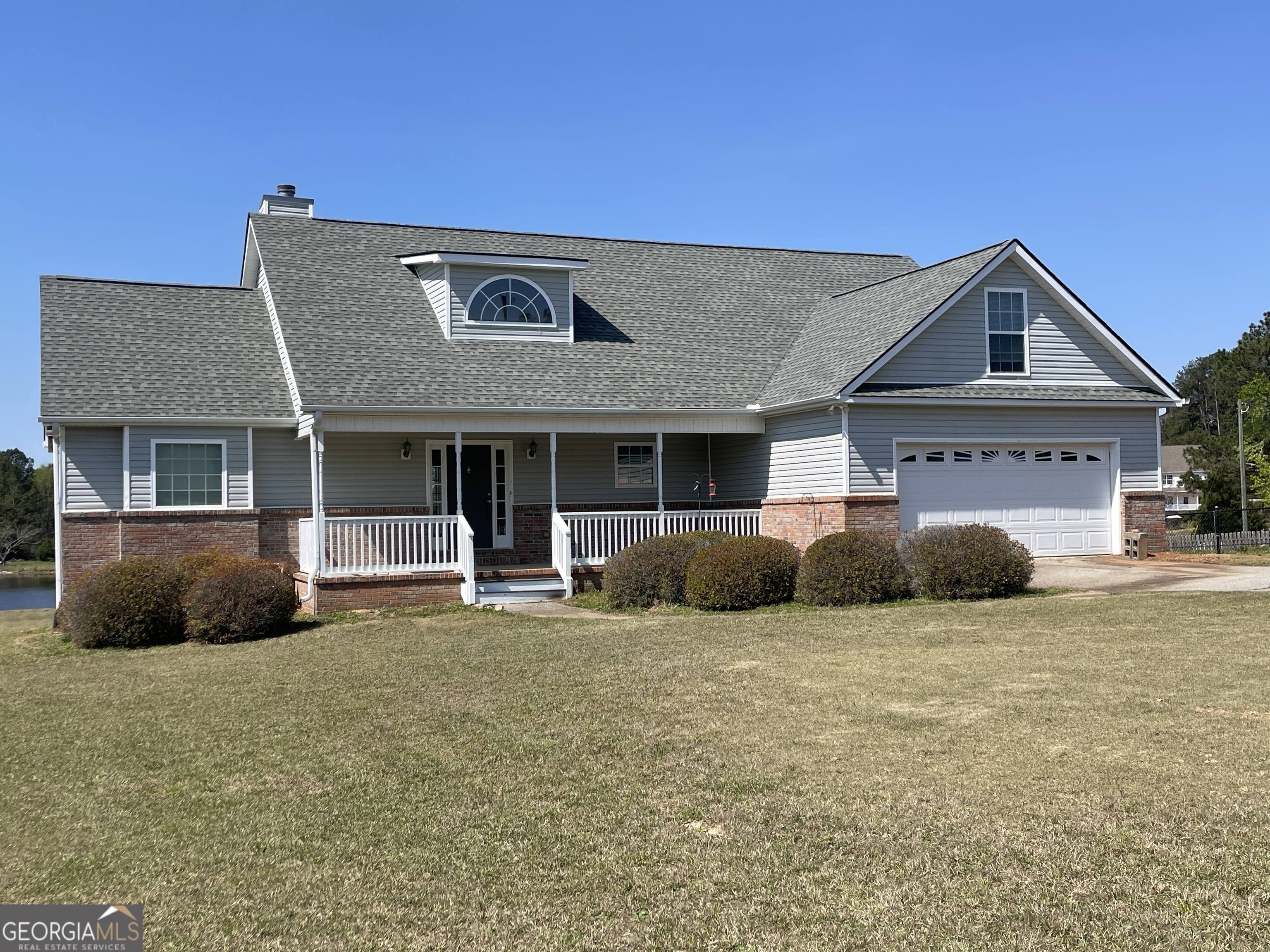 140 Woody Road Jackson, GA 30233 - Photo 1 of 1 a front view of a house with a garden