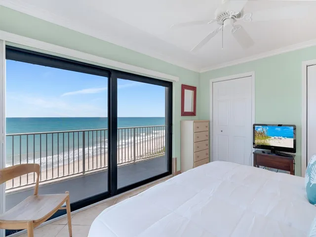 a bathroom with a granite countertop sink a toilet a mirror and shower