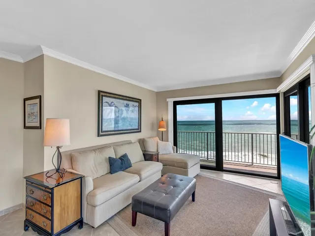 a living room with furniture and a book shelf