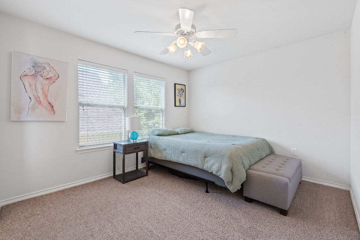 10700 Macmora Road, Unit 116 Austin, TX 78758 - Photo 16 of 26 Carpeted bedroom with a ceiling fan and baseboards
