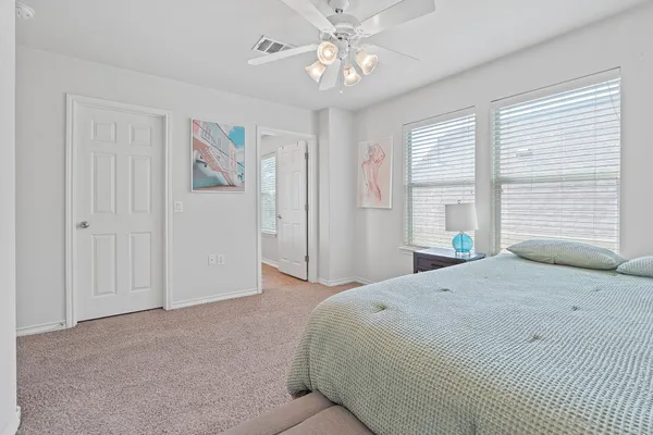 a bedroom with a bed dresser and a window