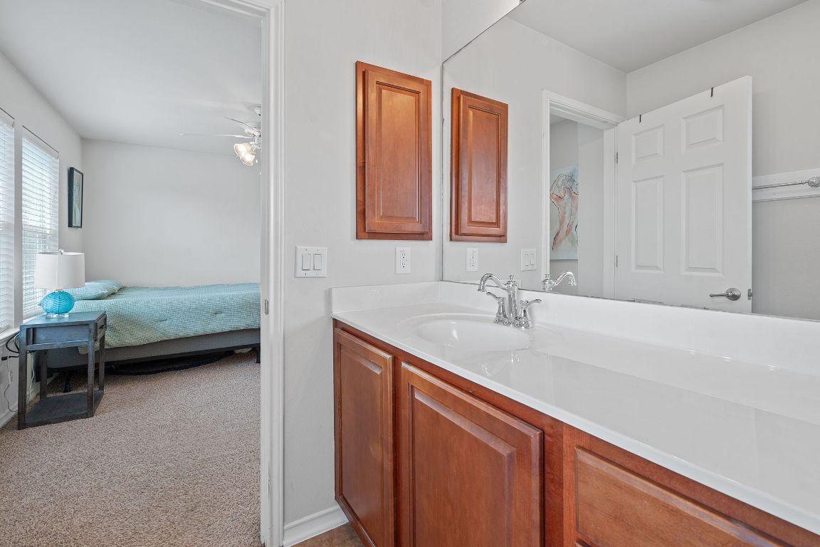 10700 Macmora Road, Unit 116 Austin, TX 78758 - Photo 18 of 26 Bathroom featuring light carpet, vanity, and ensuite bath