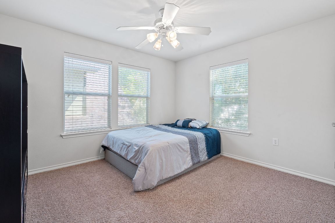 10700 Macmora Road, Unit 116 Austin, TX 78758 - Photo 20 of 26 Bedroom with carpet and a ceiling fan