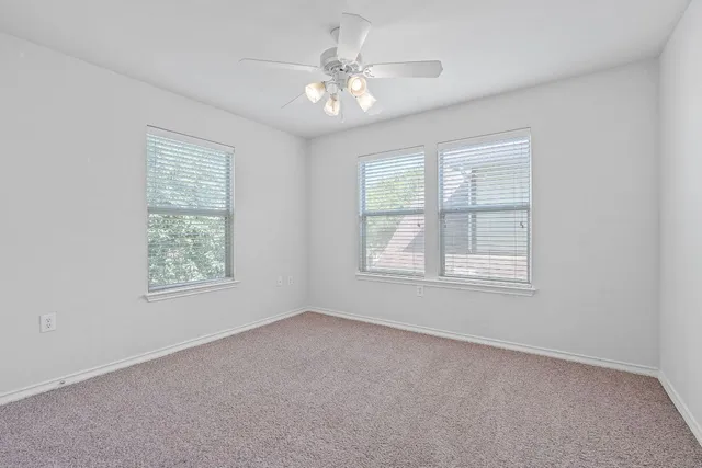 a spacious bedroom with a bed and a window