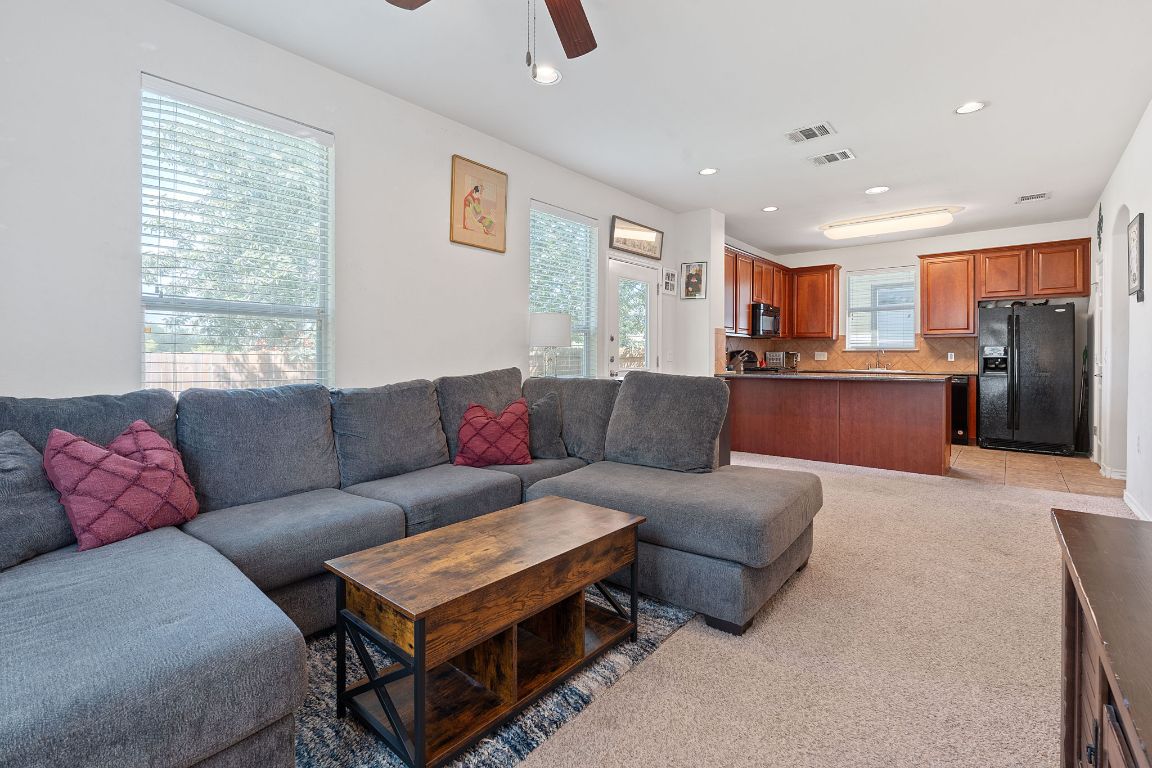 10700 Macmora Road, Unit 116 Austin, TX 78758 - Photo 4 of 26 Living area featuring light carpet, recessed lighting, and ceiling fan