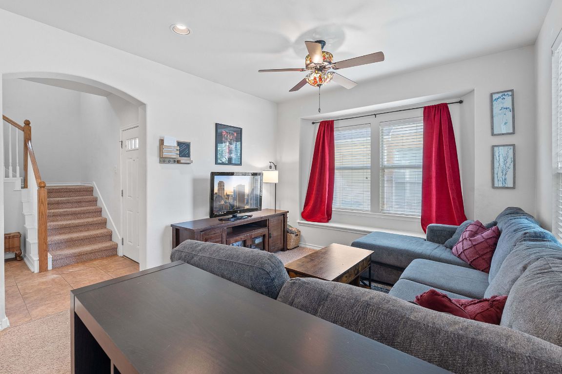 10700 Macmora Road, Unit 116 Austin, TX 78758 - Photo 5 of 26 Living area with stairs, arched walkways, a ceiling fan, recessed lighting, and tile patterned floors