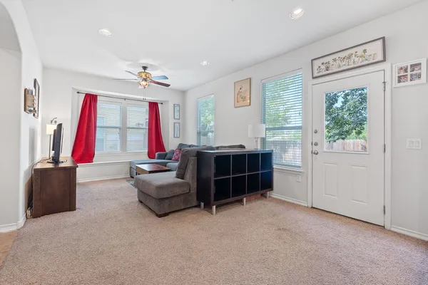 a bedroom with furniture and a large window