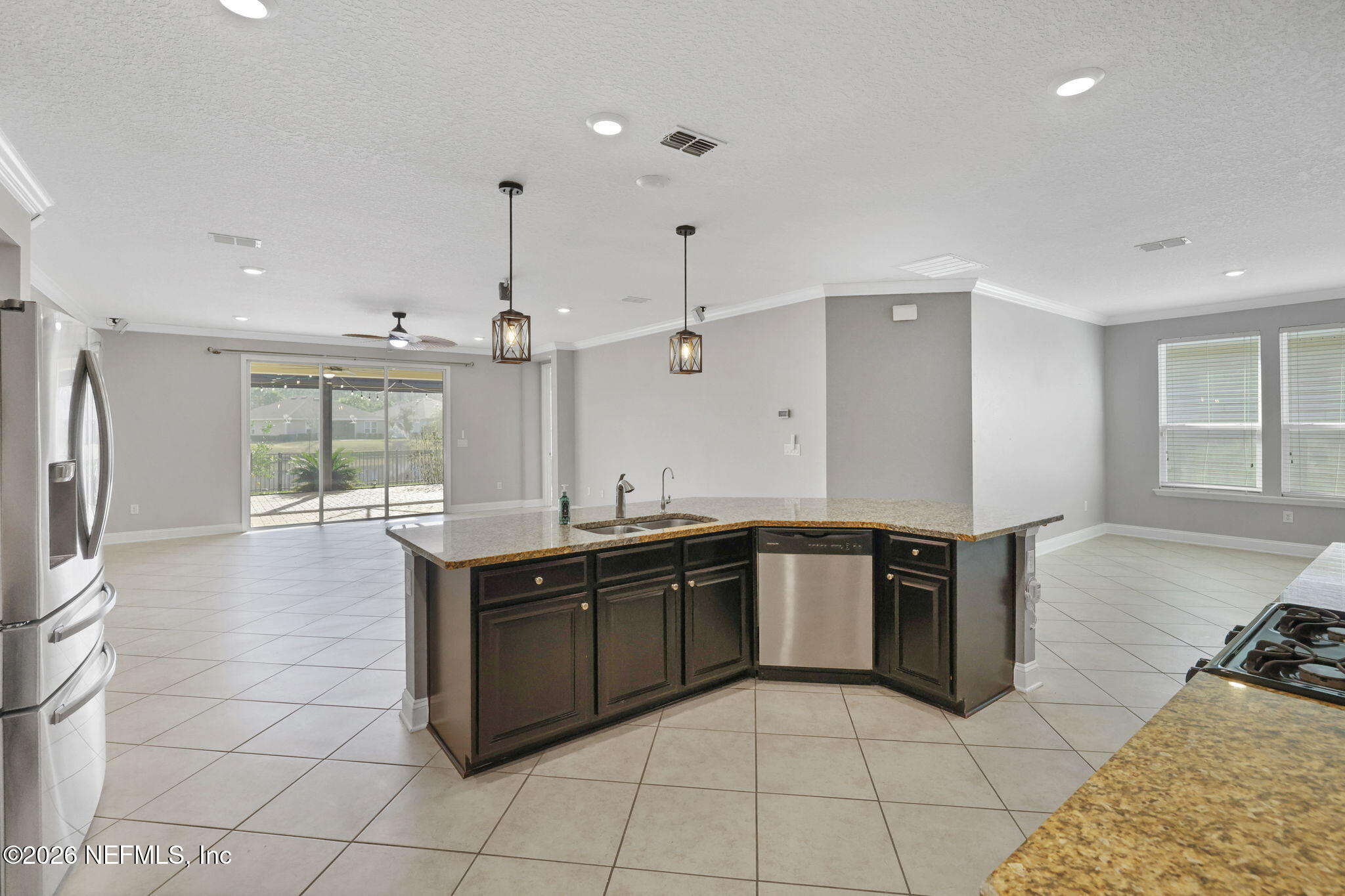 182 St Kitts Loop St. Augustine, FL 32092 - Photo 16 of 71 a kitchen with stainless steel appliances granite countertop a sink and stove
