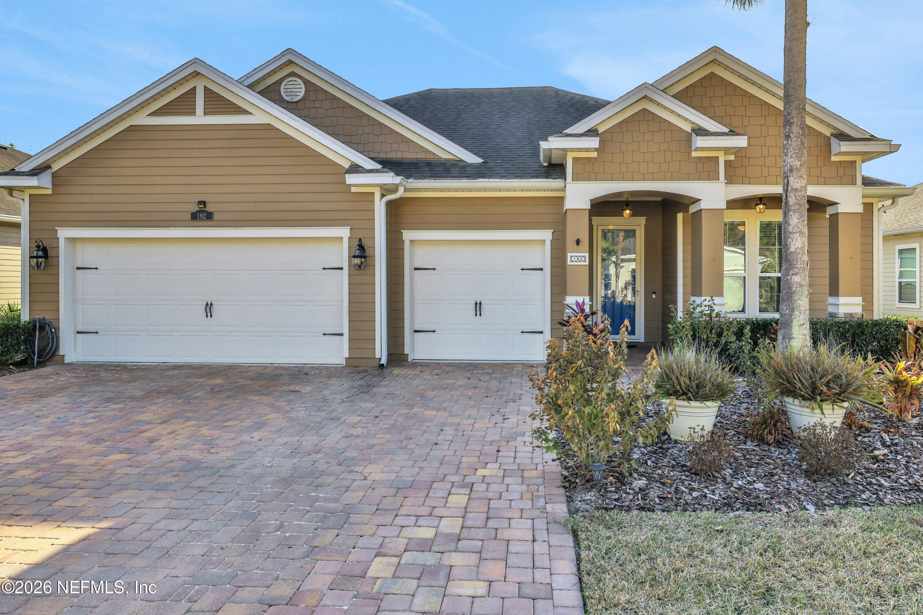 182 St Kitts Loop St. Augustine, FL 32092 - Photo 2 of 71 a front view of a house with a yard and garage
