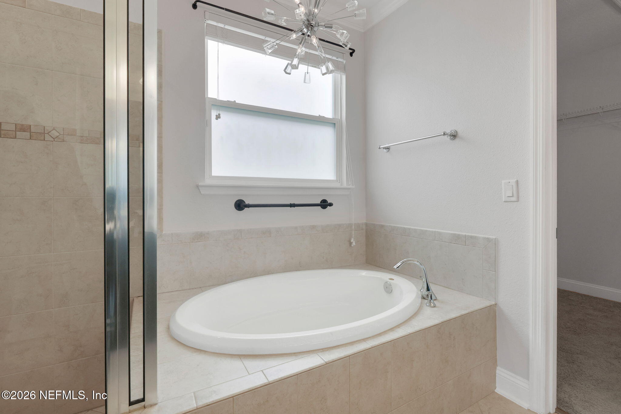 182 St Kitts Loop St. Augustine, FL 32092 - Photo 42 of 71 a bathroom with a bathtub and a window