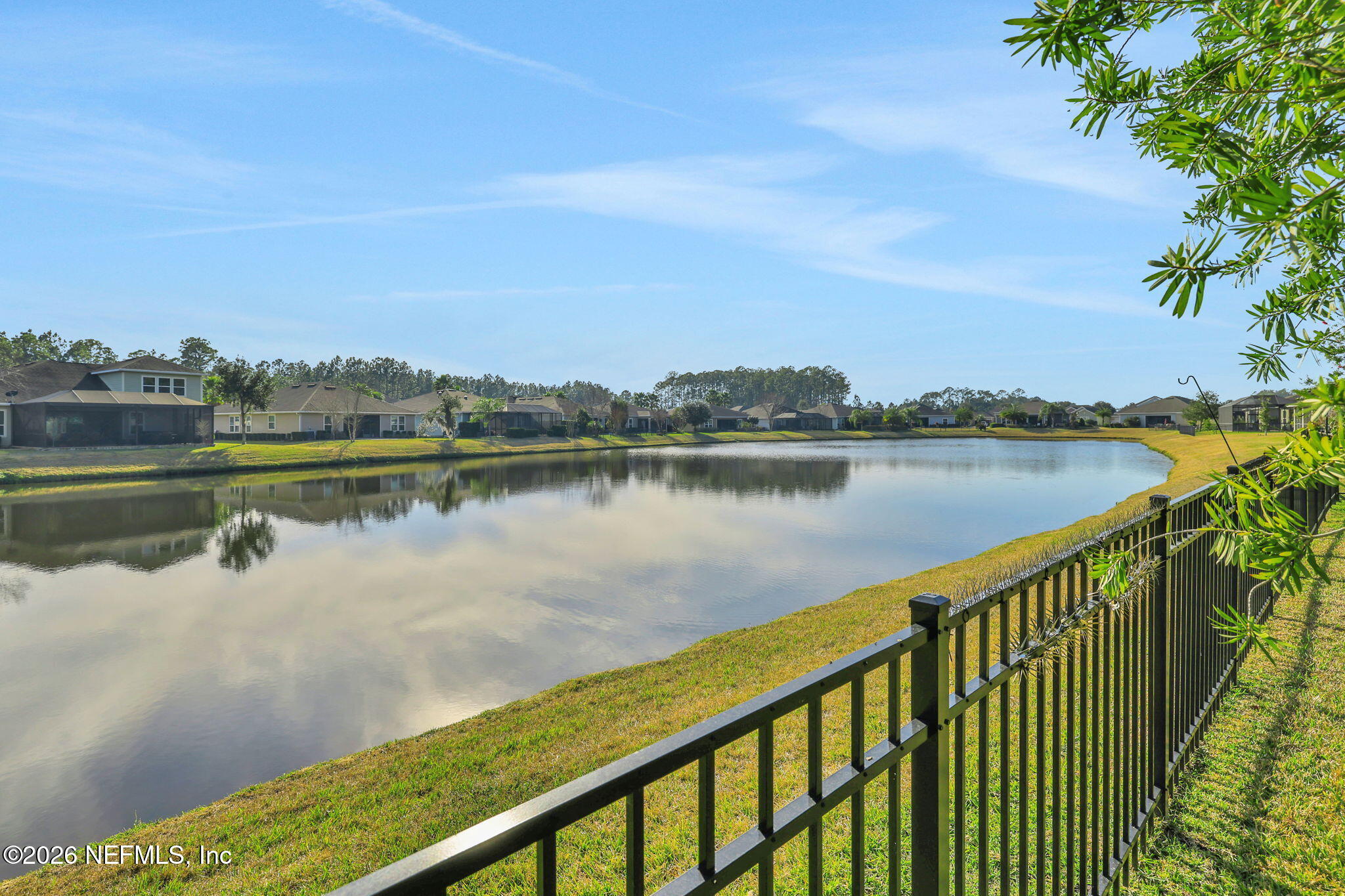 182 St Kitts Loop St. Augustine, FL 32092 - Photo 49 of 71 a view of a lake with a city skyline in the background
