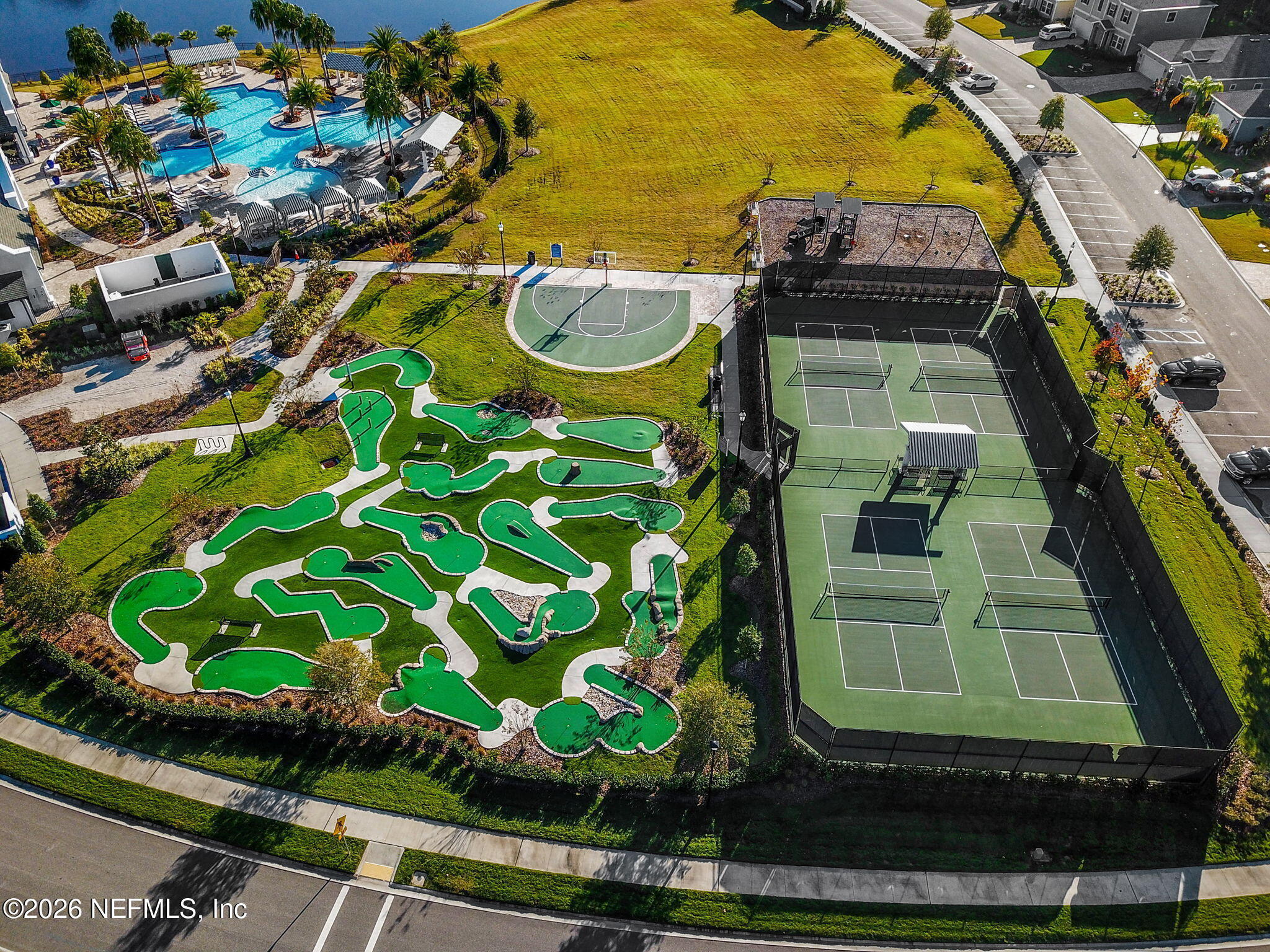 182 St Kitts Loop St. Augustine, FL 32092 - Photo 65 of 71 a view of a swimming pool with outdoor seating and plants