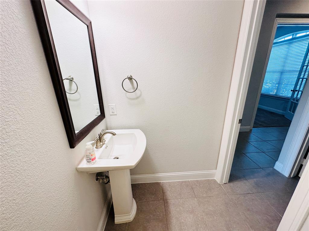 806 Davids Way Allen, TX 75013 - Photo 13 of 24 a bathroom with a sink and mirror
