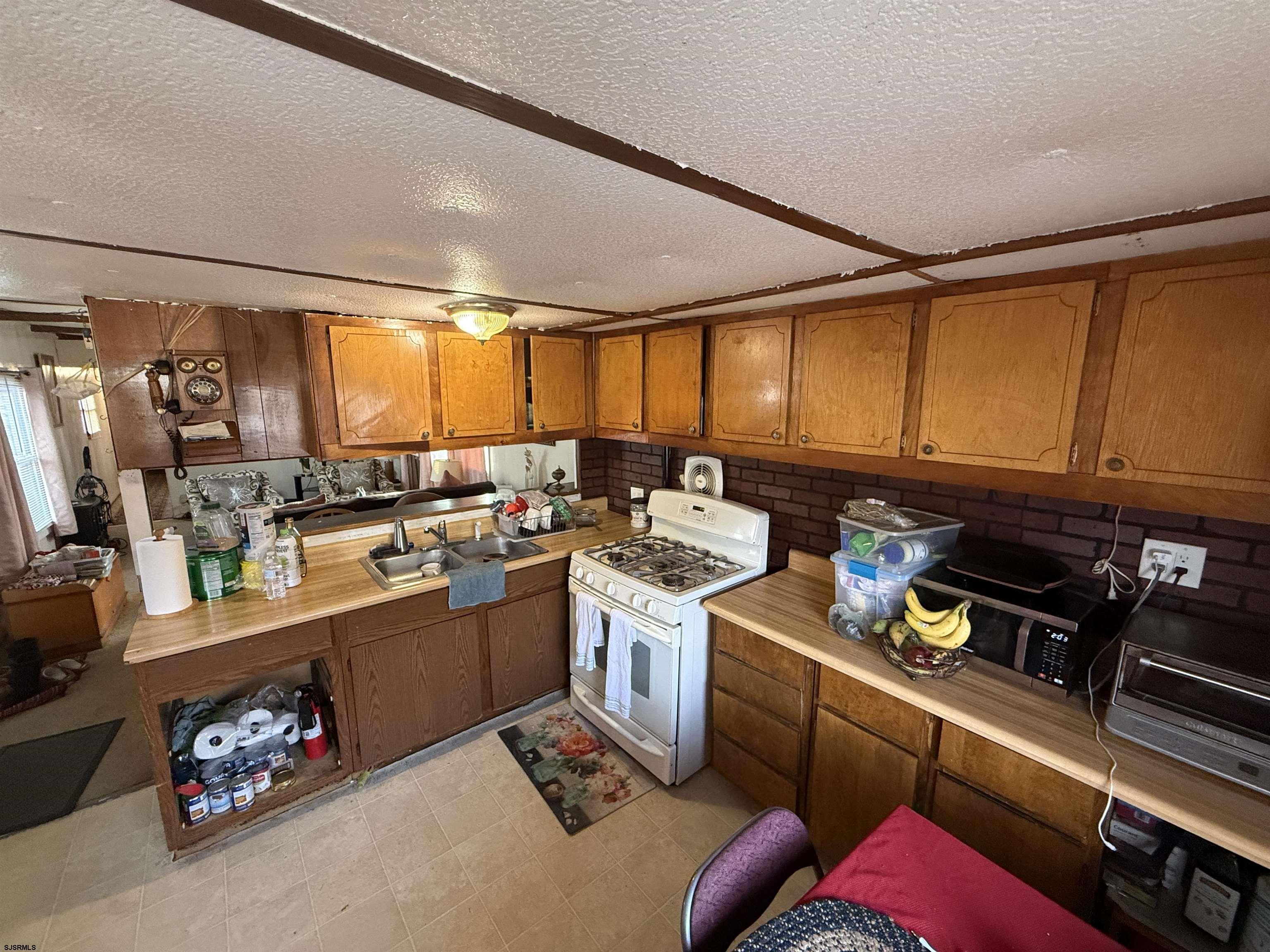 2501 Tilton Road Egg Harbor Township, NJ 08234 - Photo 3 of 20 a kitchen that has a sink and a stove