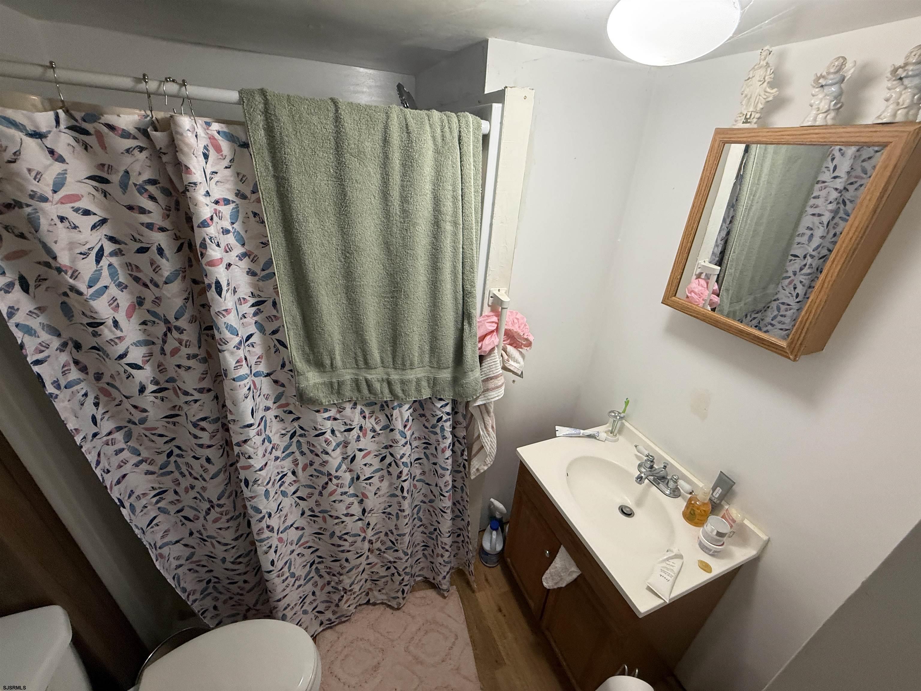 2501 Tilton Road Egg Harbor Township, NJ 08234 - Photo 9 of 20 a bathroom with a sink toilet and shower