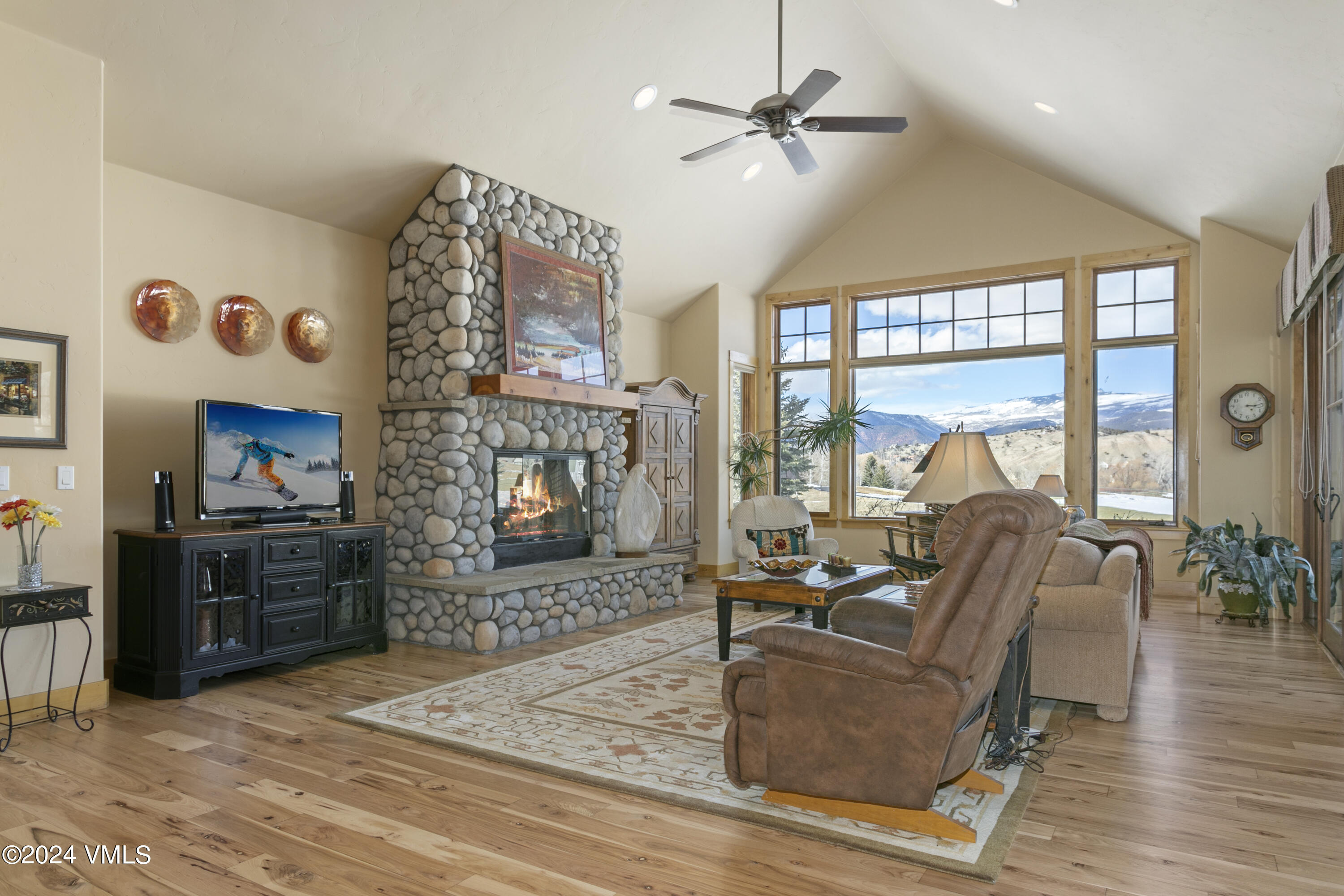 119 Sawmill Circle Eagle, CO 81631 - Photo 11 of 45 a living room with furniture a flat screen tv and a fireplace