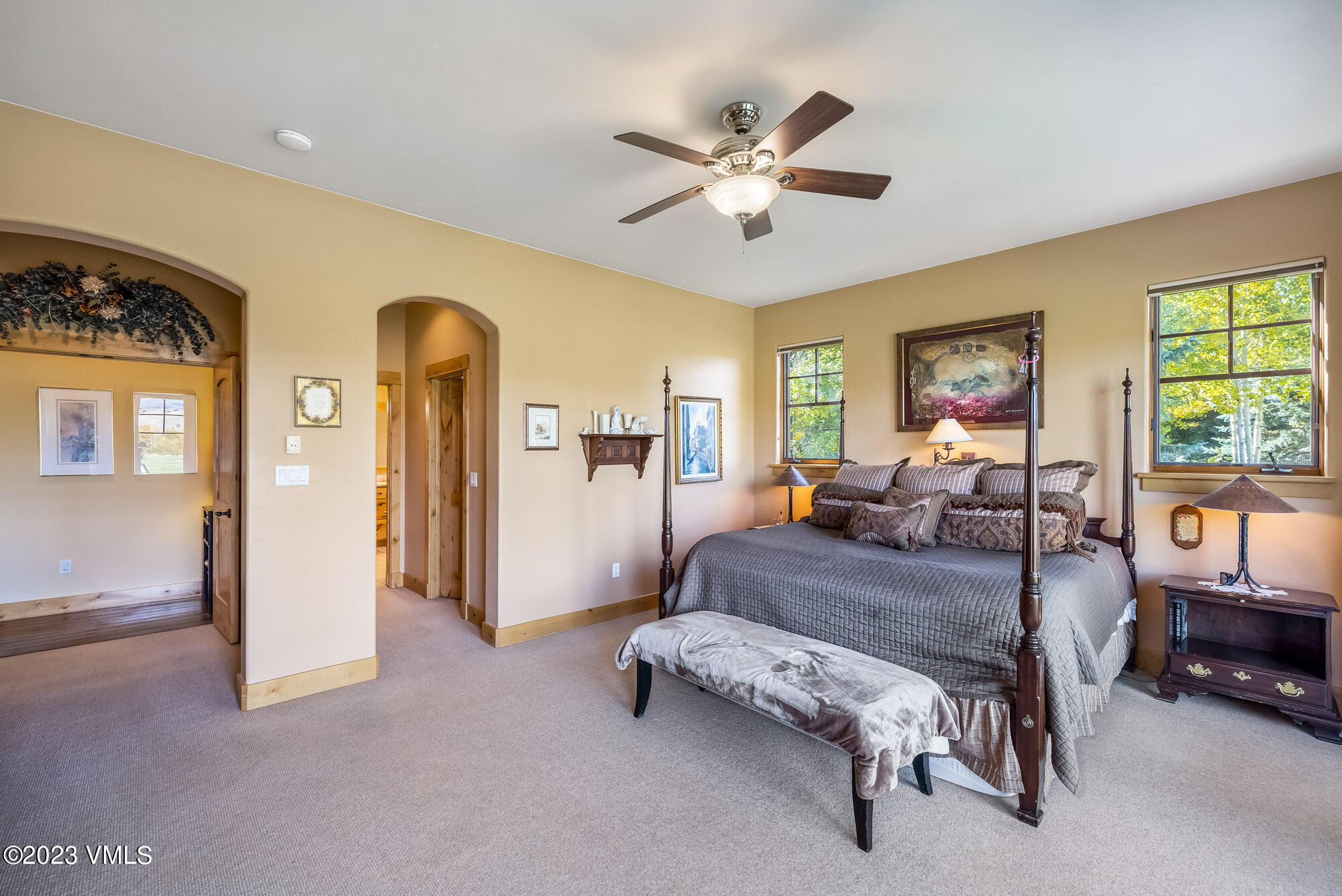 119 Sawmill Circle Eagle, CO 81631 - Photo 15 of 45 a spacious bedroom with a bed a couch and large window