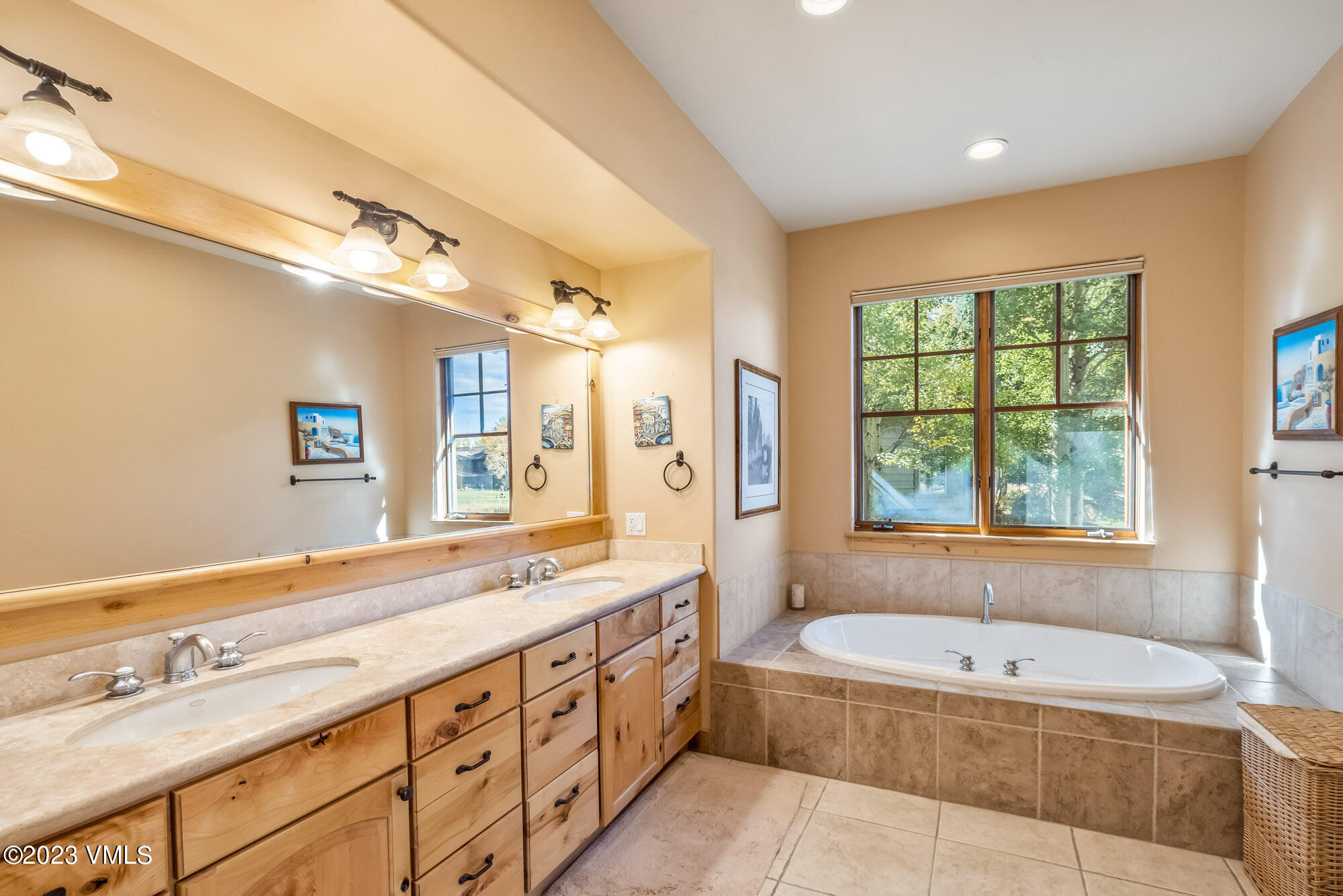 119 Sawmill Circle Eagle, CO 81631 - Photo 16 of 45 a spacious bathroom with sink a mirror a bathtub and window