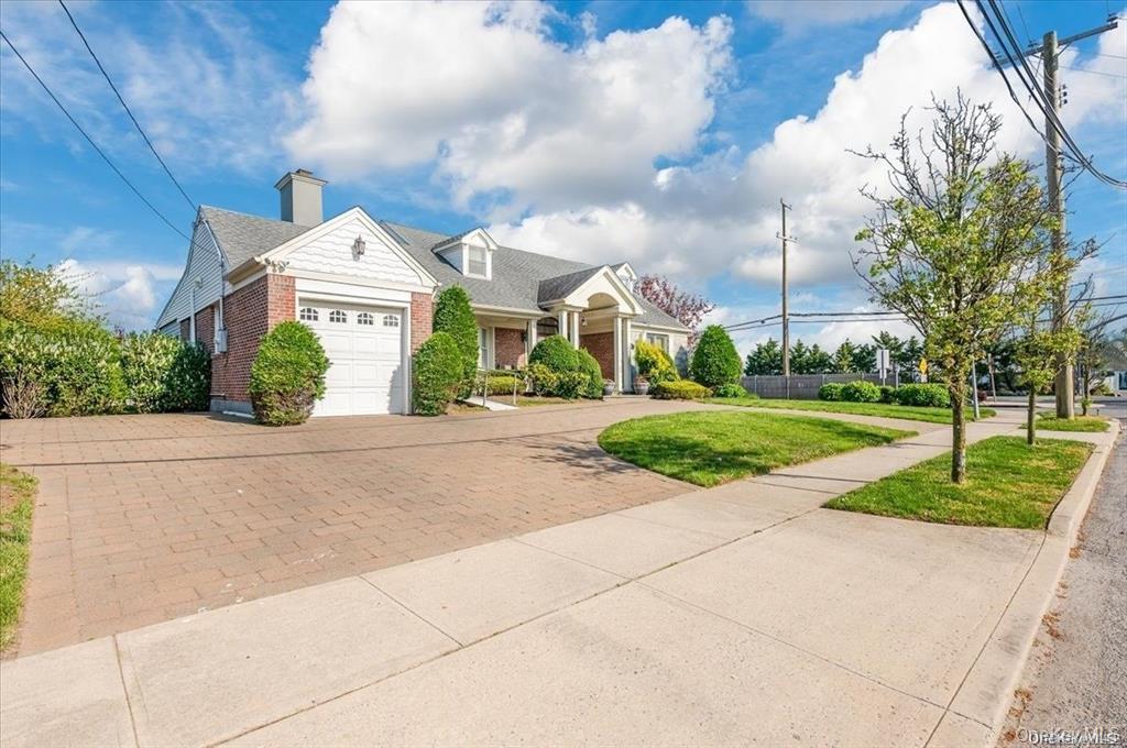 102 Richard Street Atlantic Beach, NY 11509 - Photo 1 of 2 a front view of a house with garden
