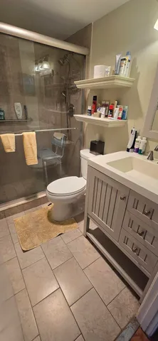 a bathroom with a sink toilet and shower