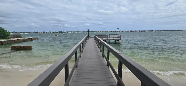 a view of a balcony with wooden chairs and a bench