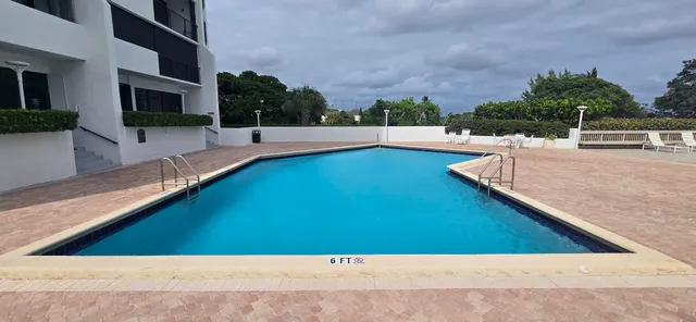 a view of a pool with a yard