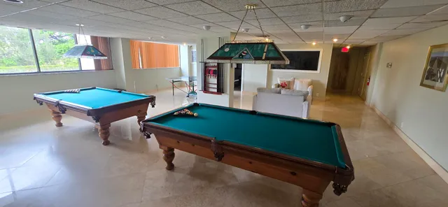 a room with table chairs and wooden floor